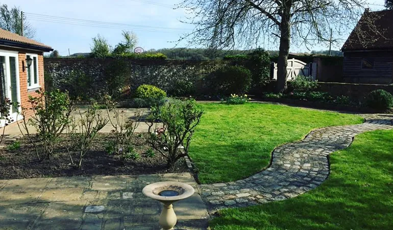 A tidy walled garden & cobbled path